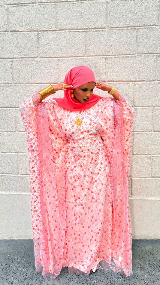 Coral Blossom Dirac – coral floral lace dirac with draped sleeves, full length